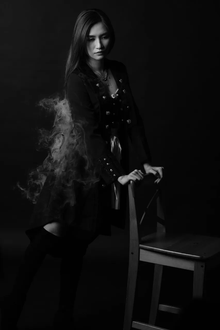 Standing beside the chair as haze fills the frame