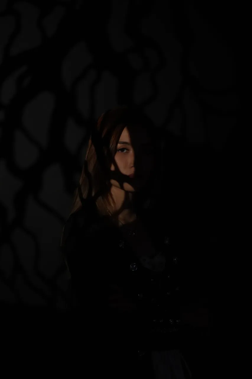 Deep shadow study — patterned light falling across the face