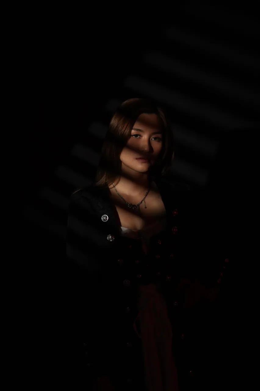 Blind shadows across the shoulders in near-total darkness