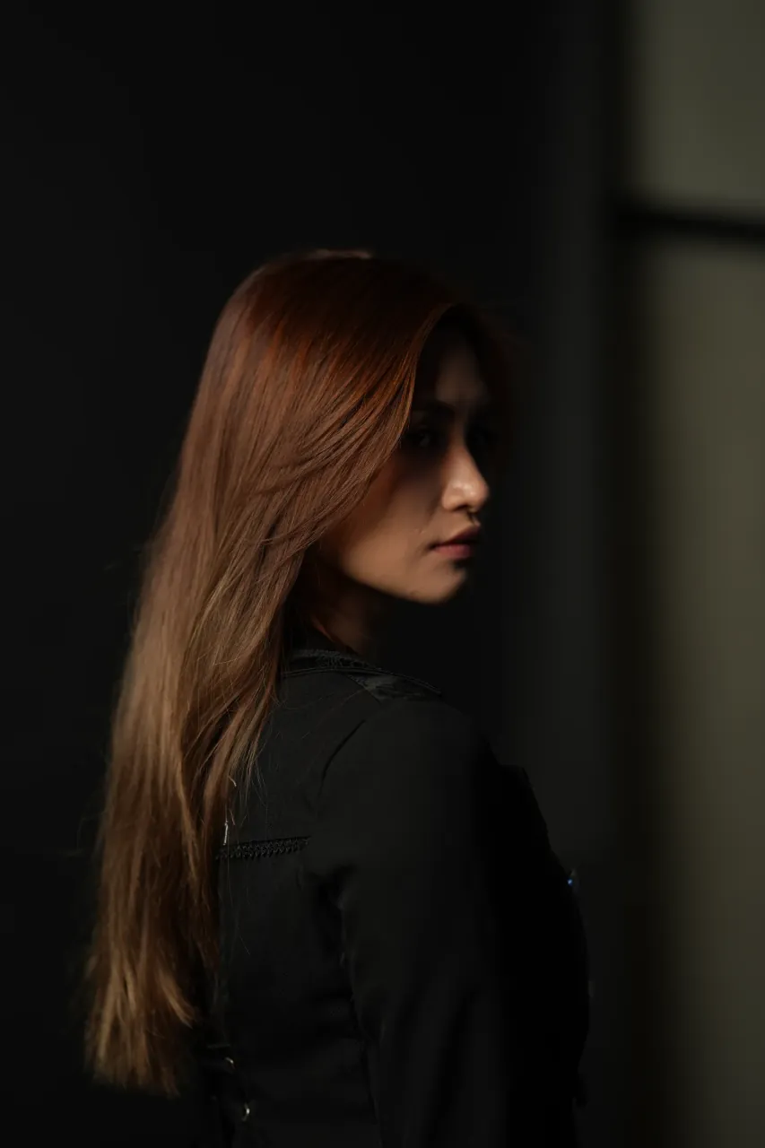 Profile turn with hair sweep, shot wide open on the 85mm