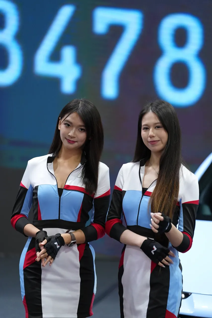 Racing-team presenters against an LED countdown board
