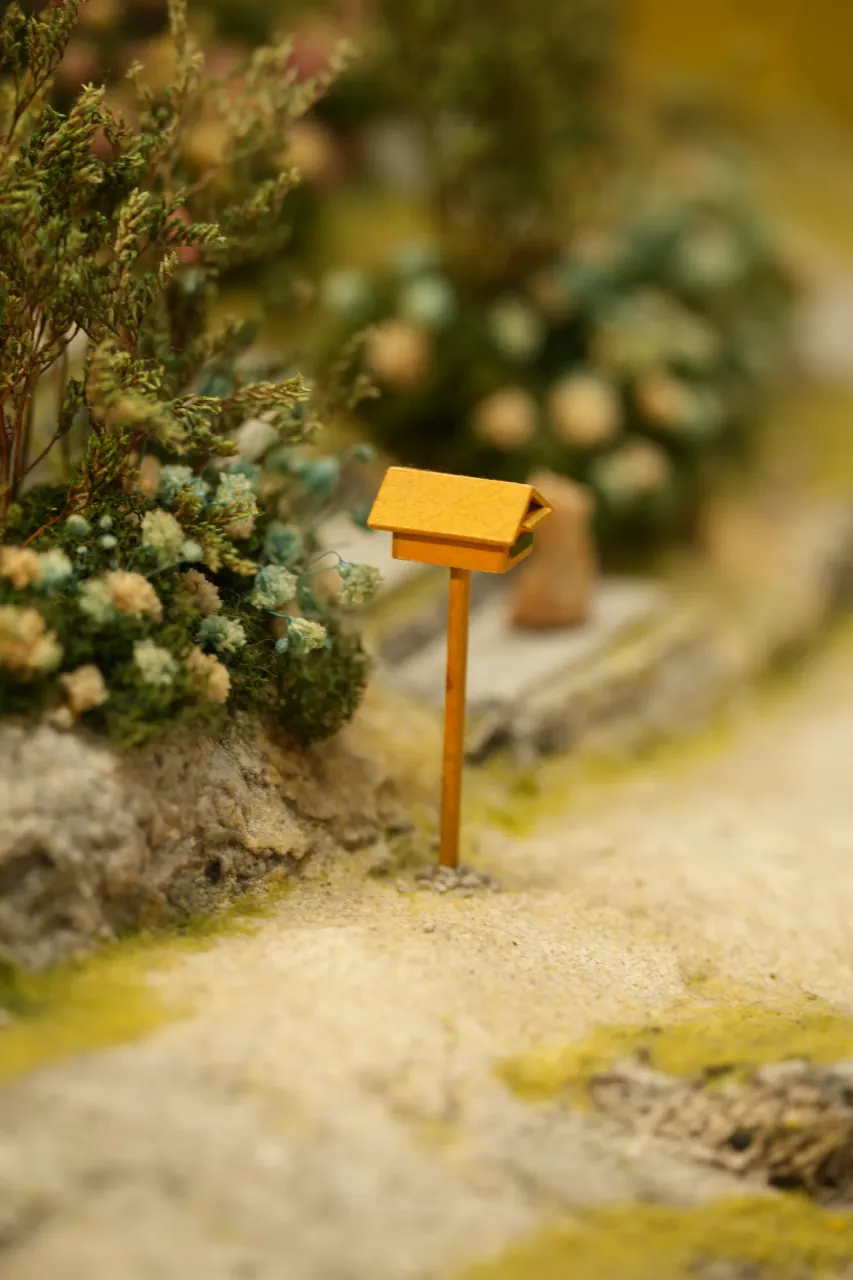 Miniature mailbox beside a garden path
