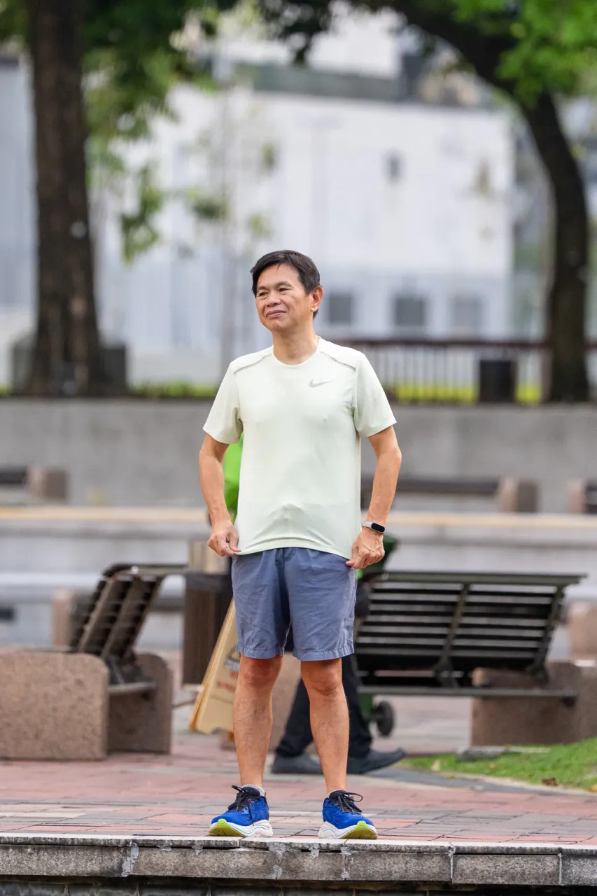 Candid street portrait — morning warmup at the KLCC jogging track