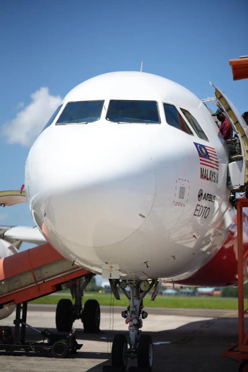 Aircraft nose and landing gear — low-angle detail at Sandakan Airport